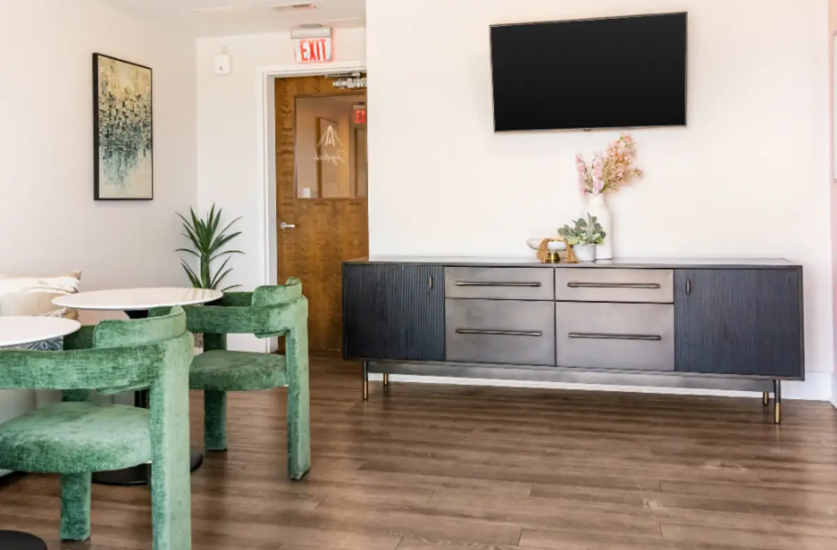 Resident study lounge with comfortable seating, meeting tables, modern furnishings, and contemporary artwork.